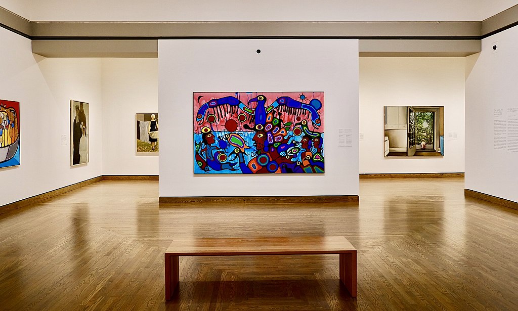 A photo of a Norval Morrisseau painting in an art gallery